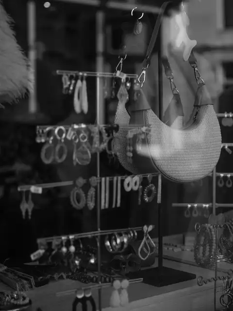 Handbags and jewelry displayed behind a shop window